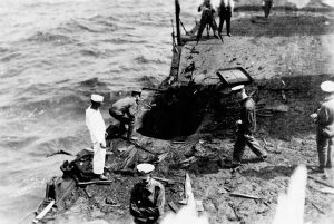 Naval personnel examining bomb damage. Photo from the US National Archives.